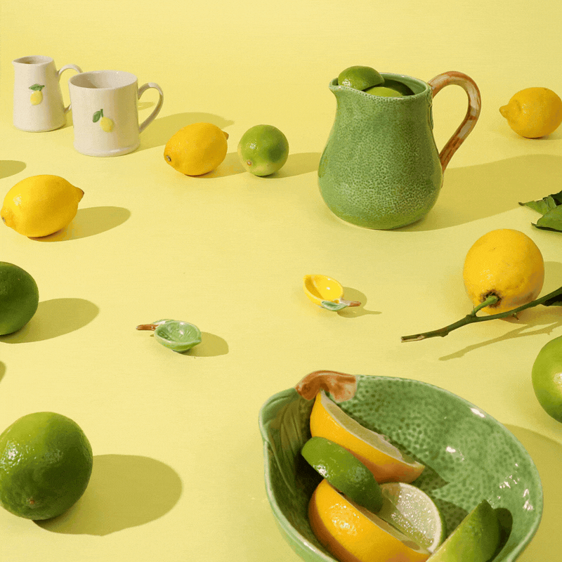 A stop motion gif of a lime jumping into some lime-shaped bowls and jugs