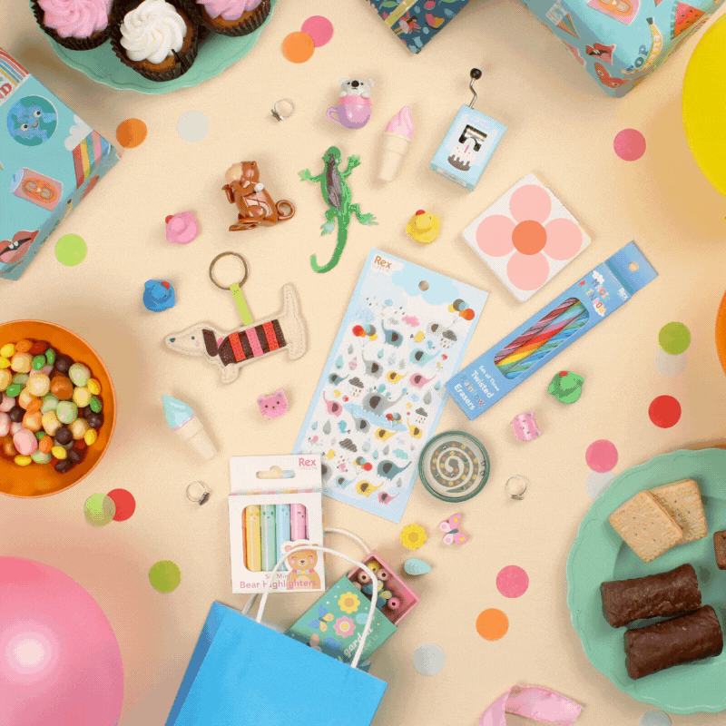 A party bag bursts open revealing little toys, games and stationery