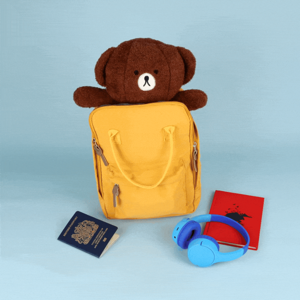 A stop motion video of a toy bear transforming into a travel neck pillow
