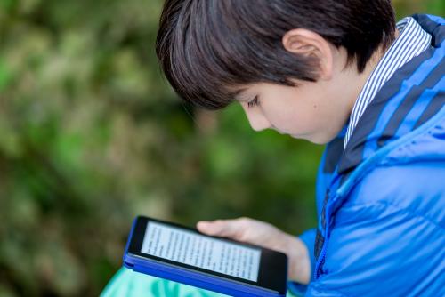 Young boy reading an ebook