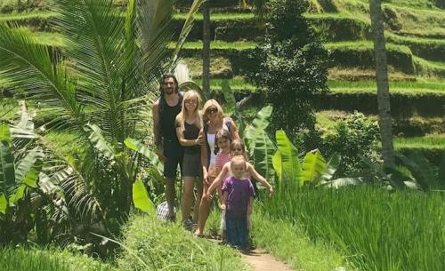family standing in the jungle