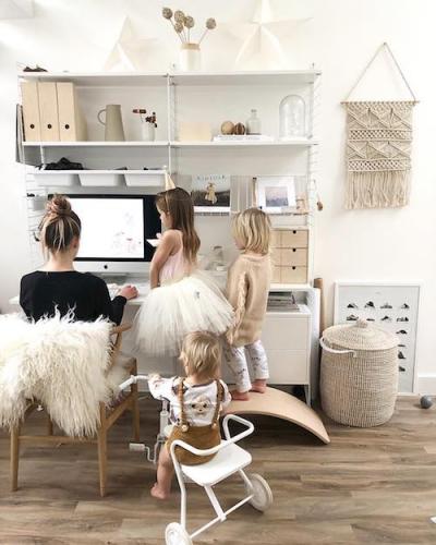 family sitting round a computer desk 