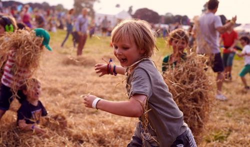 children playing with hay
