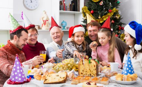 family gathered around the table together at christmas