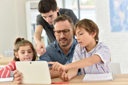 family gather around tablet pc