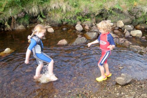 Jen's kids have a paddle in the stream Jen's kids have a paddle in the stream