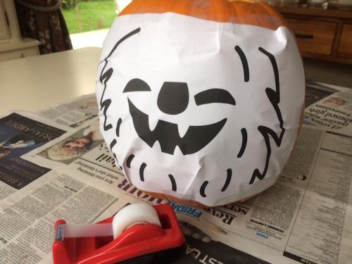 Put your stencil on your pumpkin