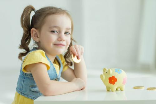 young girl with piggy bank