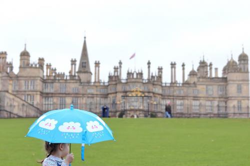little-girl-standing-with-blue-umbrella