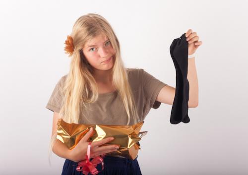 young girl is not happy with socks as a present