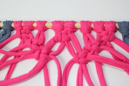 Macrame knots being tied to create a pattern