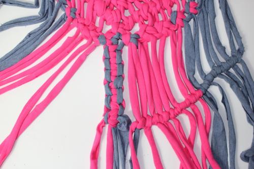 2 extra strips of material being tied in to the macrame decoration