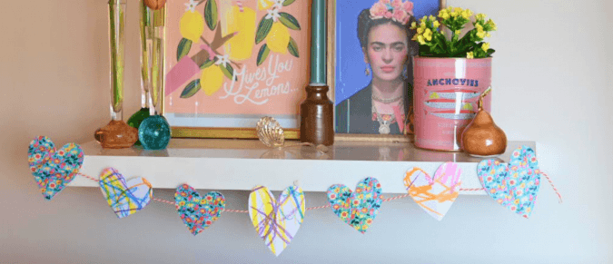 Homemade heart garland strung across a shelf