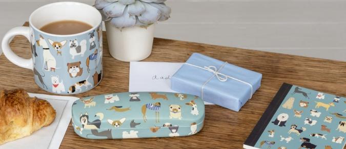 A mug, glasses case and notebook with a dog print, and an envelope with 'Dad' written on it