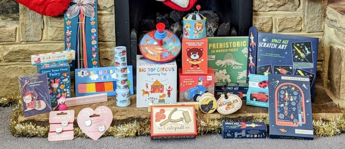 Collection of stocking fillers in front of a fireplace