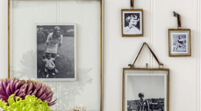 Retro photo frames on wall with flowers