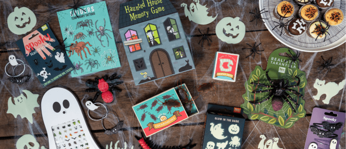 Several Halloween accessories laid out on wooden background