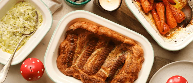 Pie, leeks and carrots in white serving dishes