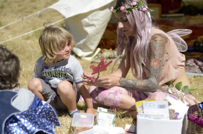 fairy and child at crafting at festival