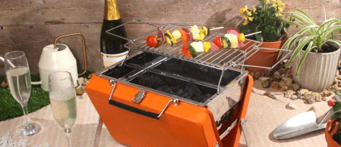 Portable bbq suitcase in a garden party