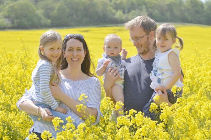 family photo in yellow field of flowers