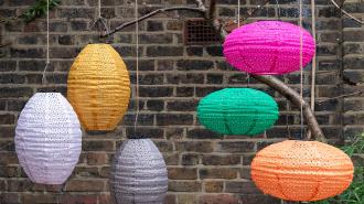 Bright hanging solar lanterns, suggesting gardening-themed gifts.