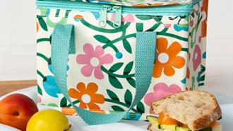 Insulated lunch bag in off-white, adorned with pretty imagery of flowers and butterflies.