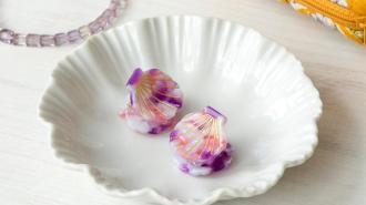 Two pink mini hair clips in shell shaped trinket tray