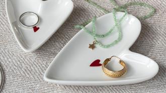 White heart-shaped jewelry dishes with red heart detail, perfect for storing rings, bracelets, and necklaces.