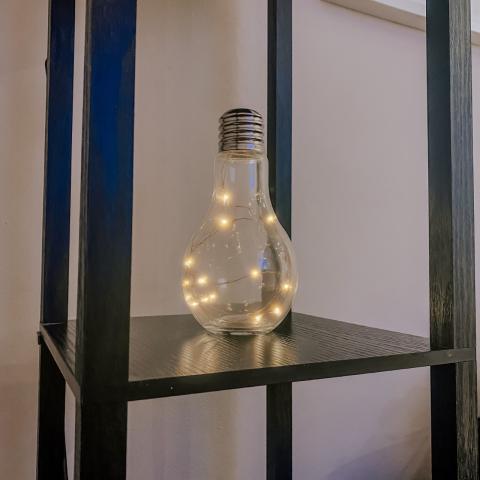 Lightbulb table lamp on a shelf