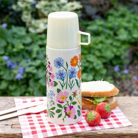 Wild Flowers flask and cup on a gingham napkin with a sandwich