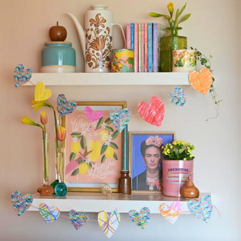 Homemade paper heart garlands strung across shelves