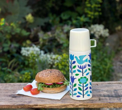 Folk Doves flask and cup on a bench with a bread roll and salad