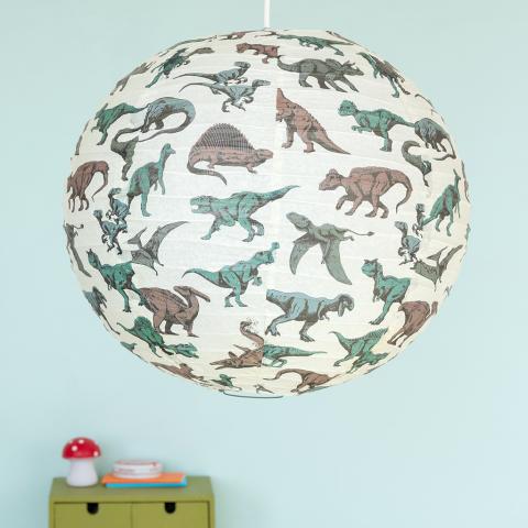 White paper lampshade with dinosaur decoration installed in room