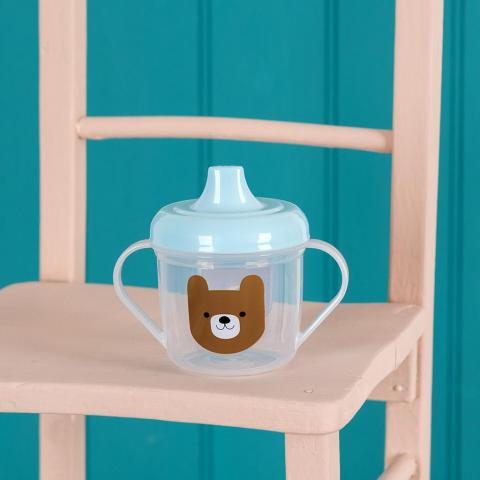 Bruno the Bear children's sippy cup on a chair