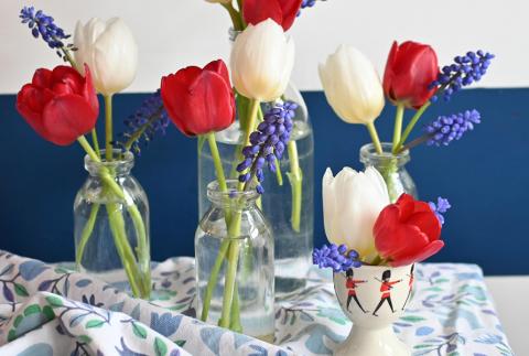 Red, white and blue flowers in a little jars