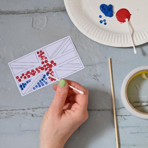 A hand painting a union flag