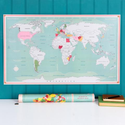 Scratch world map hanging on a turquoise background