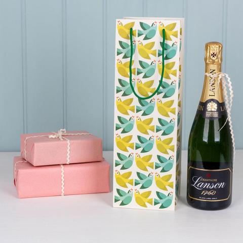 Love Birds gift bag with a bottle of champagne and wrapped gifts