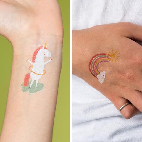 Unicorn and rainbow temporary tattoos on a child's arm