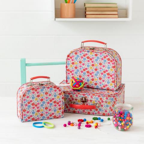Tilde storage suitcases on a table with beads and hairbands