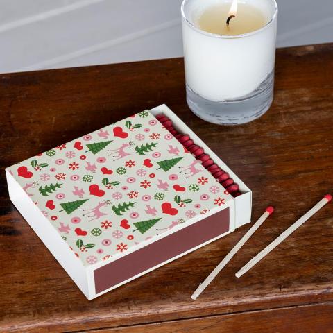 Box of 50s Christmas design long matches with a candle