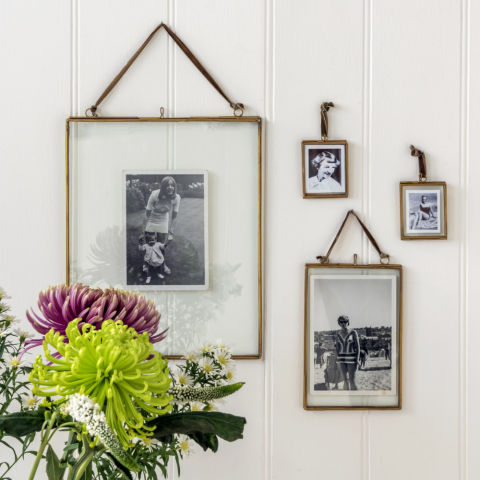Hanging brass frames with a bouquet of flowers