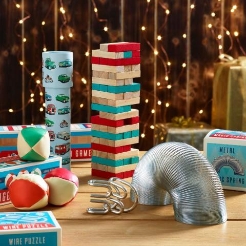 Traditional toys and games against a fairy light backdrop