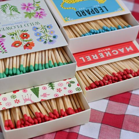 Four matchboxes filled with colourful matches