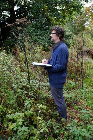 Jan Konopka sketching in the woods