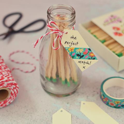 Green tipped matches in a jar, with a gift tag