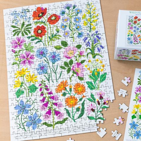 Wild Flowers puzzle on a table, with a few pieces left to complete
