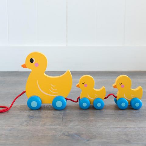 Duck Family wooden pull toy on a floor