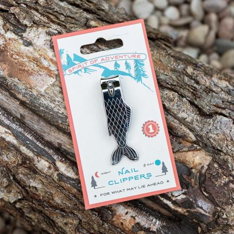Fish-shaped nail clippers on a log